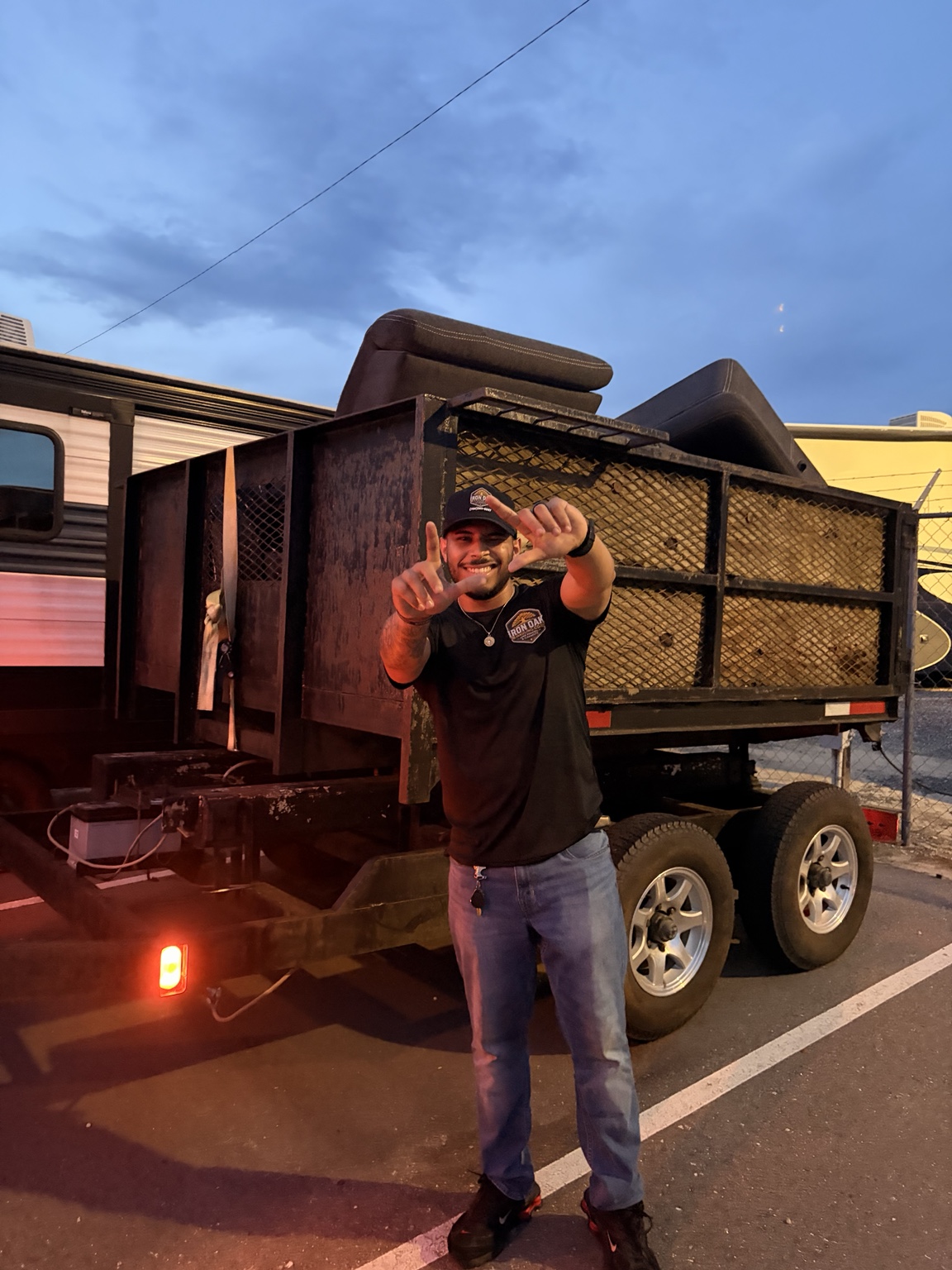 Ralph standing beside an Iron Oak trailer loaded with furniture